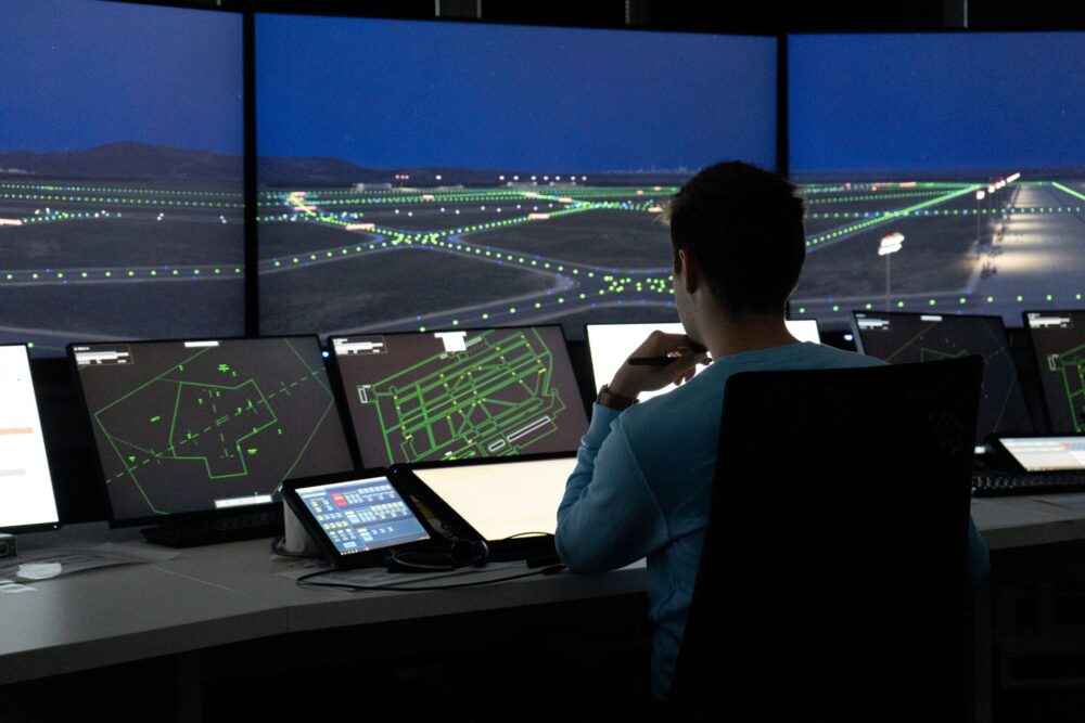 Air traffic controller sitting in front of simulator for Air Traffic Control